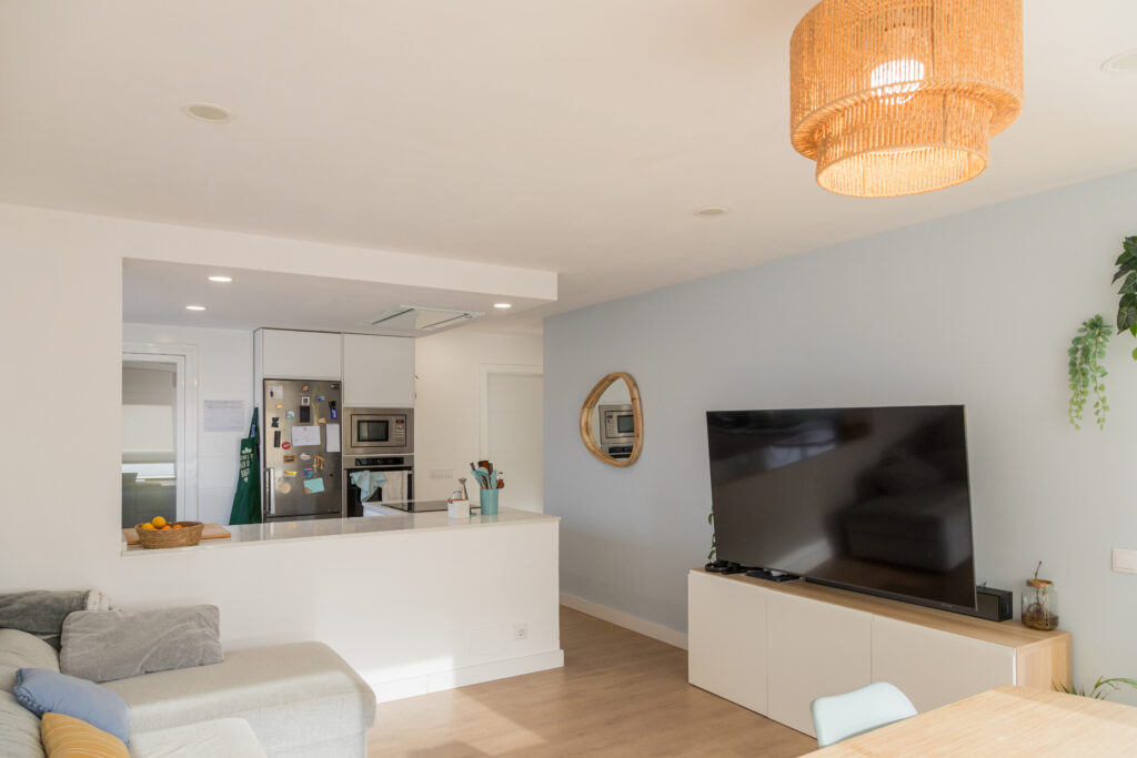 salón luminoso con gran tele y abierto a cocina